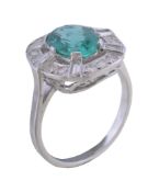 An emerald and diamond cluster ring , the oval cut emerald within a pierced surround of baguette