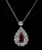 A ruby and diamond pendant, the pear cut ruby collet set within a surround of brilliant cut
