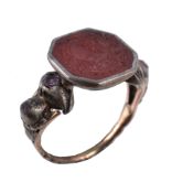 An antique signet ring , the central octagonal panel engraved with a crest with a rampant griffin