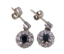 A pair of sapphire and diamond cluster ear pendants, the brilliant cut diamond surmounts above a