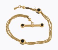 An early 20th century French gold and onyx Albert chain, circa 1900, composed of plaited strands,