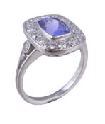 A tanzanite and diamond panel ring, the rectangular cut tanzanite collet set within a surround of