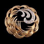 An Austrian 18 carat gold and diamond brooch, the swirled brooch set with a spray of eight cut