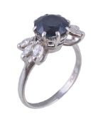 A sapphire and diamond ring , the central circular cut sapphire flanked by two trios of marquise