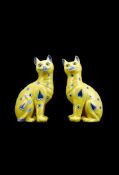 Galle, a pair of faience models of seated cats by Emile Galle, circa 1900, glazed and painted with