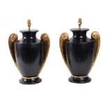 A pair of black and gold glazed ceramic urn table lamps, modern, each with twin scrolled handles,