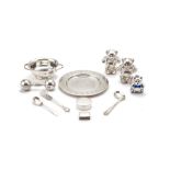 A collection of silver and silver coloured christening items, to include: a silver plate by Asprey,