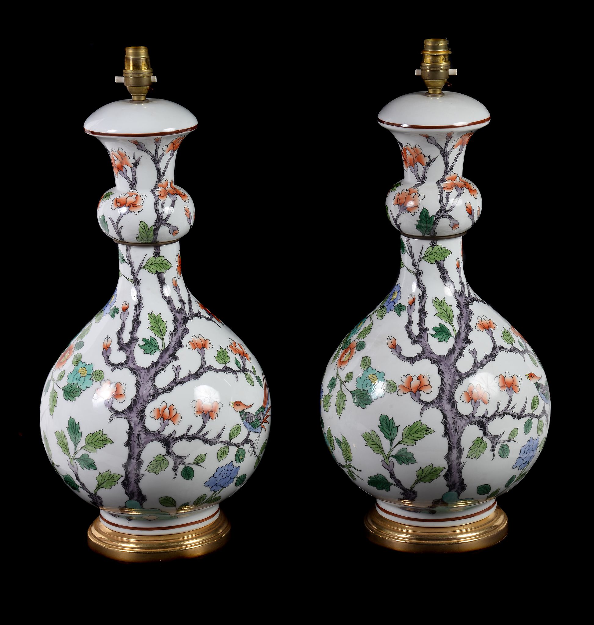 A pair of French porcelain and gilt metal mounted vases fitted as table lamps, modern, decorated