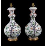 A pair of French porcelain and gilt metal mounted vases fitted as table lamps, modern, decorated
