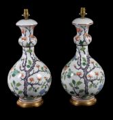 A pair of French porcelain and gilt metal mounted vases fitted as table lamps, modern, decorated