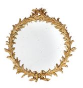 A giltwood oval wall mirror, in George III style , 19th century, in the manner of John Linnell, the