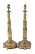 A pair of gilt, repousse worked and cast bronze table lamps, second quarter 19th century and later