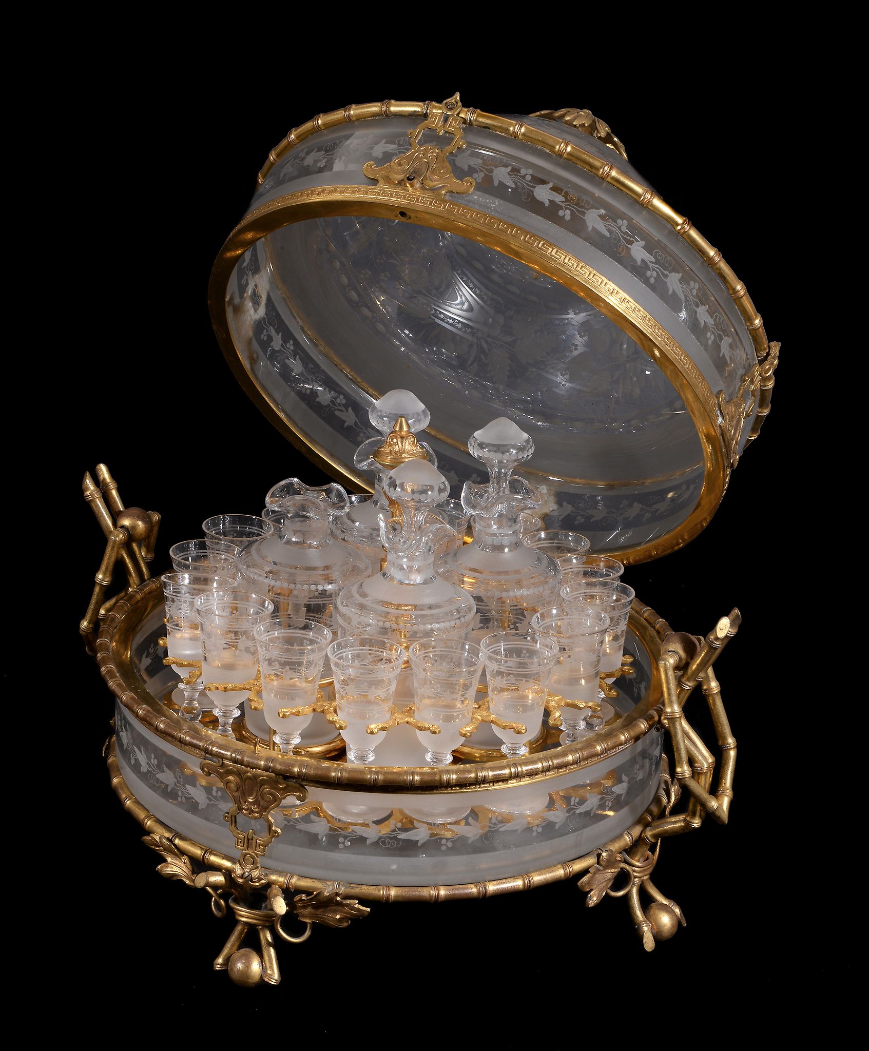 A French frosted and engraved glass spirit set in a gilt-metal and glass fitted case , late 19th