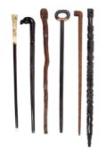 Six various walking sticks, late 19th and early 20th century, comprising a west African stained