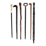 Six various walking sticks, late 19th and early 20th century, comprising a west African stained