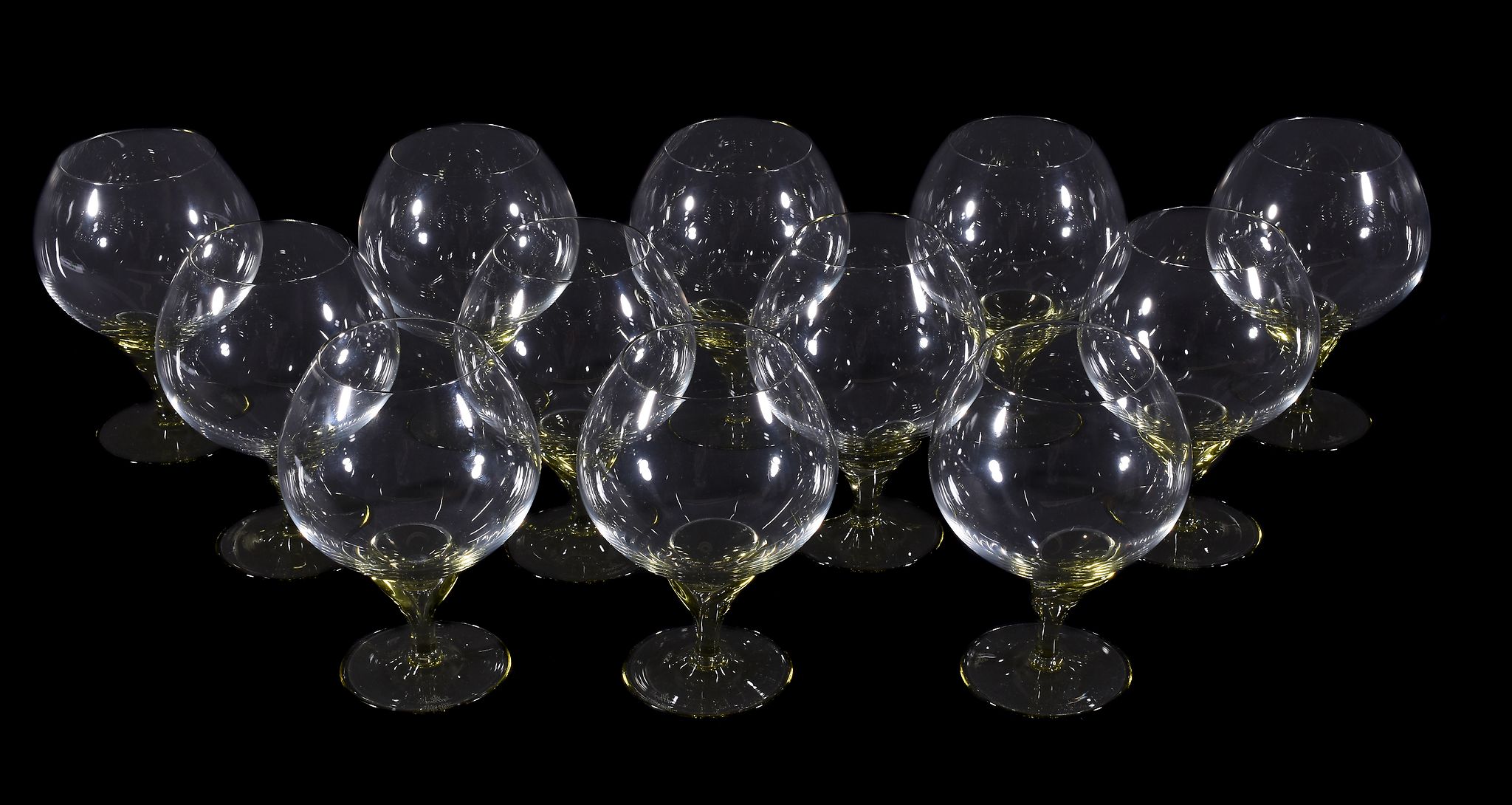 Twelve modern Rosenthal Studio Linie brandy balloon glasses, with pale-green glass stems and