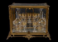 A Continental glass liqueur set in a fitted case, late 19th century, the glass gilt with bands of