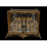 A Continental glass liqueur set in a fitted case, late 19th century, the glass gilt with bands of