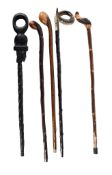 A quantity of assorted walking sticks, 20th century, including carved wood examples; and three shoe