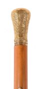 A late 18th century gold and malacca walking stick, the baluster shaped grip with decorative panels