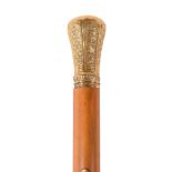 A late 18th century gold and malacca walking stick, the baluster shaped grip with decorative panels