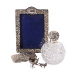 An Edwardian silver mounted photo frame by Henry Matthews, Birmingham 1901, chased with foliate