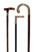 Ω An early 20th century tortoiseshell and gold walking stick , the tortoiseshell grip, with a 9