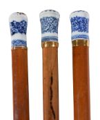 Three various blue and white porcelain mounted malacca walking canes, 19th century, with yellow