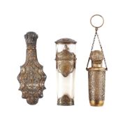 Three French silver or silver gilt mounted clear glass scent bottles, all with boar's head