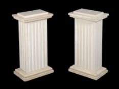 A pair of polished stone columnar plinths, late 20th century, of rectangular section, with fluted
