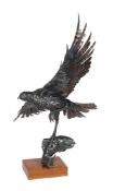 An oxidised steel welded scuplture, late 20th century, modelled as an eagle in flight, a salmon