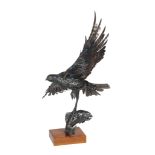 An oxidised steel welded scuplture, late 20th century, modelled as an eagle in flight, a salmon