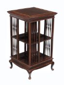 A mahogany and inlaid revolving bookcase , early 20th century, with spindle galleried elements, on