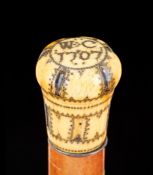 Ω A Queen Anne pique worked ivory mounted malacca walking stick, the top of the bulbous grip with