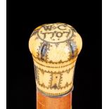 Ω A Queen Anne pique worked ivory mounted malacca walking stick, the top of the bulbous grip with