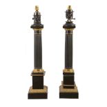 A pair of patinated and gilt metal columnar table lamps in Neoclassical taste, 20th century, with