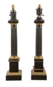 A pair of patinated and gilt metal columnar table lamps in Neoclassical taste, 20th century, with