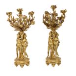 A pair of French gilt bronze figural three light candelabra, late 19th century, the sockets cast as