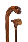 A Continental carved and stained wood walking stick with grip modelled as a the head of a parrot,