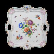 A Meissen shaped square tray, late 19th century, modelled en rocaille and painted with deutsche