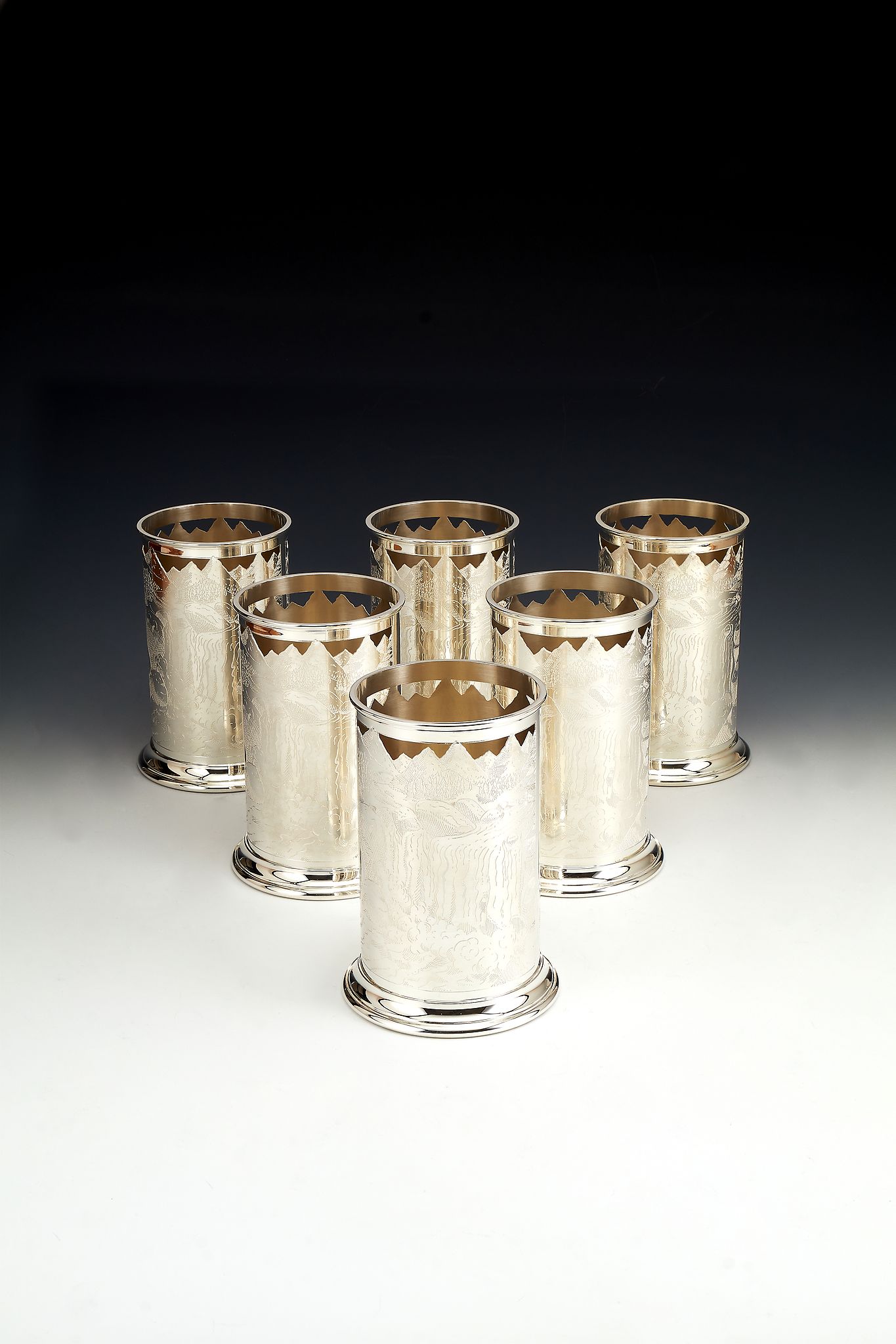 Asprey, a set of six silver cylindrical bottle holders by Asprey, London 1995, pierced and engraved