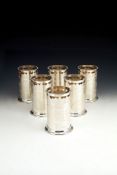 Asprey, a set of six silver cylindrical bottle holders by Asprey, London 1995, pierced and engraved