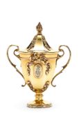 An Edwardian silver gilt cup and cover by George Fox, London 1903, with a pine cone finial to the