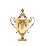 An Edwardian silver gilt cup and cover by George Fox, London 1903, with a pine cone finial to the