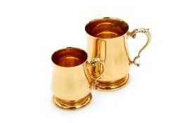 Two 18 carat gold baluster mugs by Prestons Ltd, London 1993, with leaf-capped double scroll