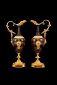 A pair of French patinated and parcel gilt bronze models of ewers, in the Neoclassical taste, 19th