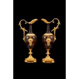 A pair of French patinated and parcel gilt bronze models of ewers, in the Neoclassical taste, 19th