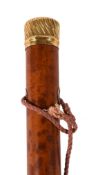 A late 18th century gold and malacca walking stick, the grip with gadrooned decoration, the top