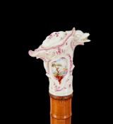 A German porcelain mounted bamboo cane, 19th century, with Rococco style mount and horn ferrule,