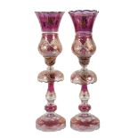 A pair of Bohemian/Czech purple-flashed, clear and gilt glass table lustres and storm shades, 67cm
